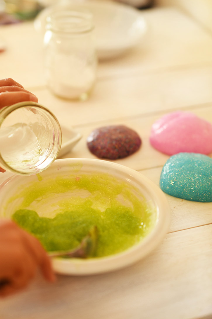 How To Make Rainbow Slime - Add A Mixture of Borax and Water to the Elmers Glitter Glue Into A Bowl, Then Stir - Cool and Easy Crafts for Kids and Teens - Ingredients and Step by Step Tutorial for Making Slime At Home - Cheap DIY Projects for Teens and Teenagers - Girls and Boys Love Making Slime